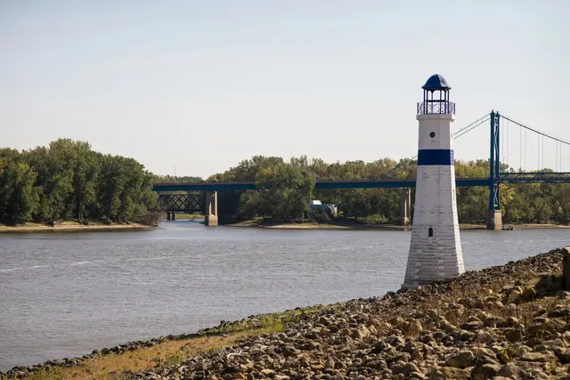 Riverfront lighthouse and suspension bridge